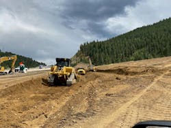 three_pieces_of_heavy_equipment_moving_dirt_for_th